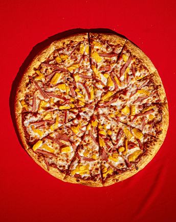 A pizza sitting on top of a red table.