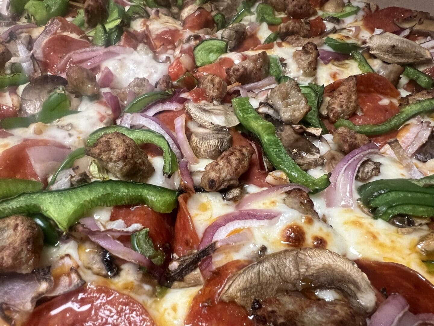 A close up of some pizza with mushrooms and peppers