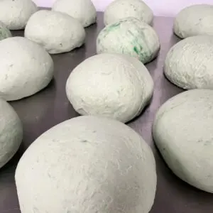 A bunch of balls are laying on the table